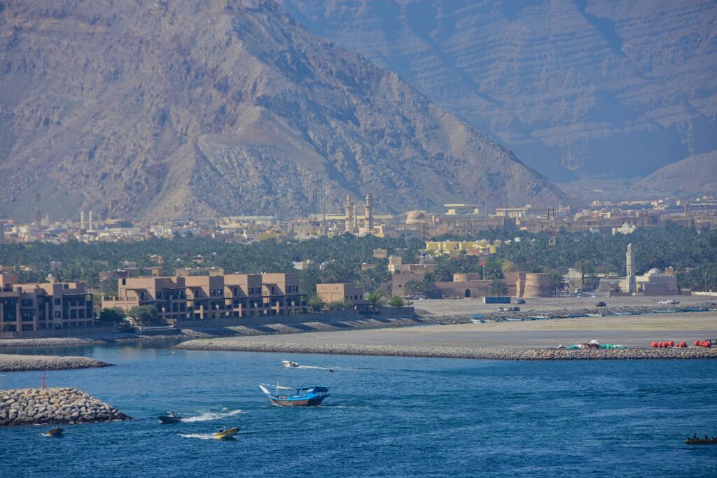 Scenic view of the sea against hills in Oman