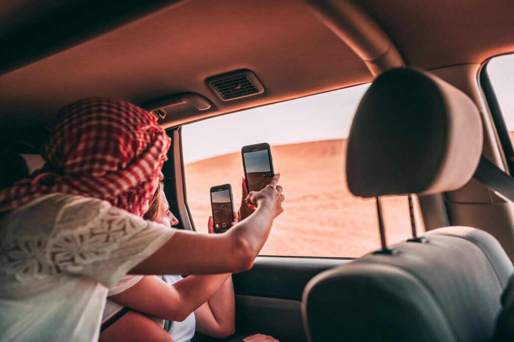 A couple enjoying a private 4x4 desert safari in Dubai, with a romantic sunset and stunning sand dunes.