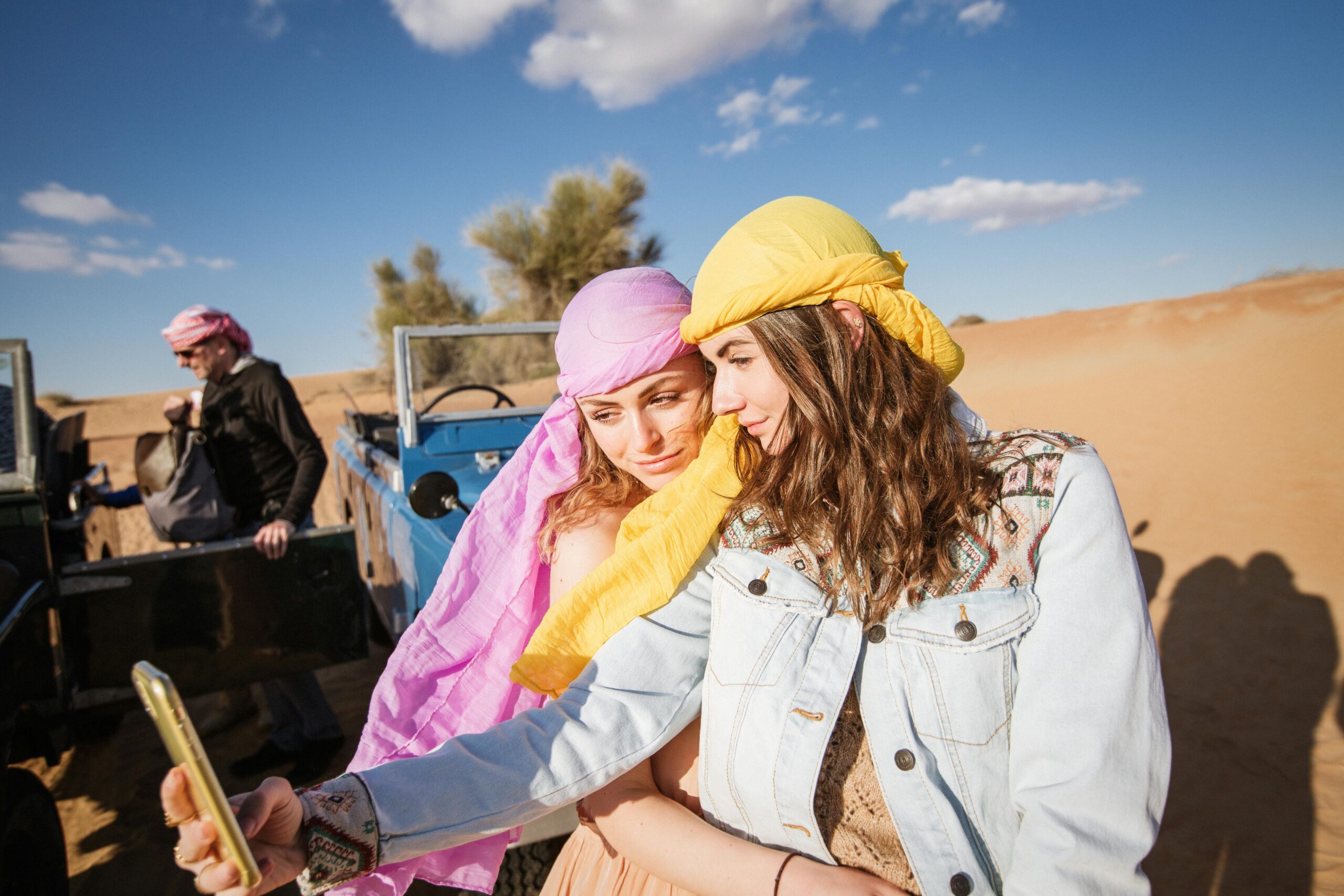 Tourists enjoying thrilling desert safari near me with 4x4 ride, camel trekking, and sunset views in the golden dunes